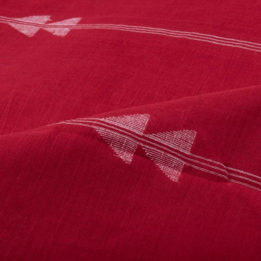 Red plain cotton Jamdani fabric draped to highlight its soft texture and white arrow motif design